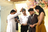 Parish priest blessing the couple during engagement
